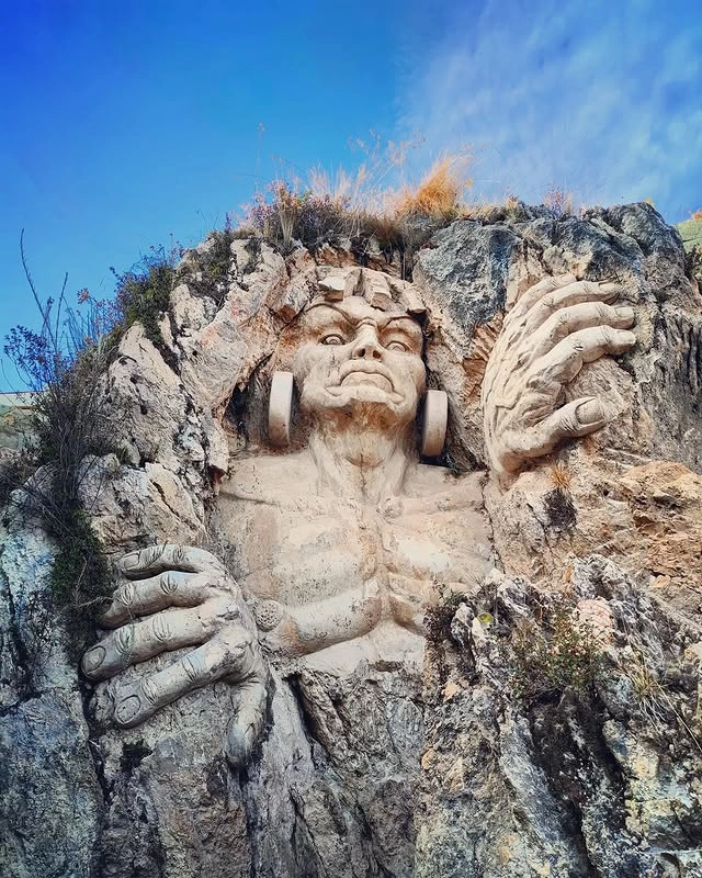 Rock-carved figure at the Abode of the Gods