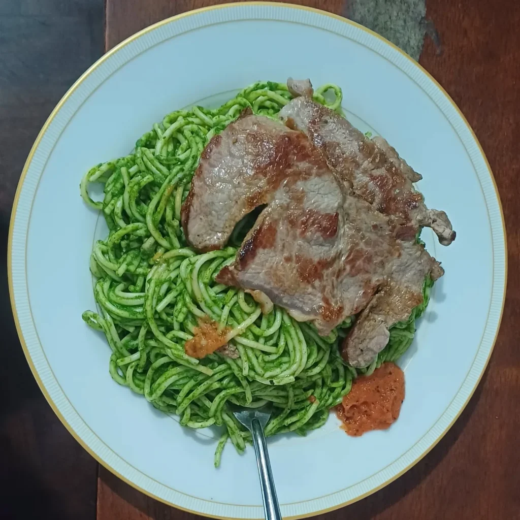 Tallarines verdes con chuleta plato típico de la costa peruana