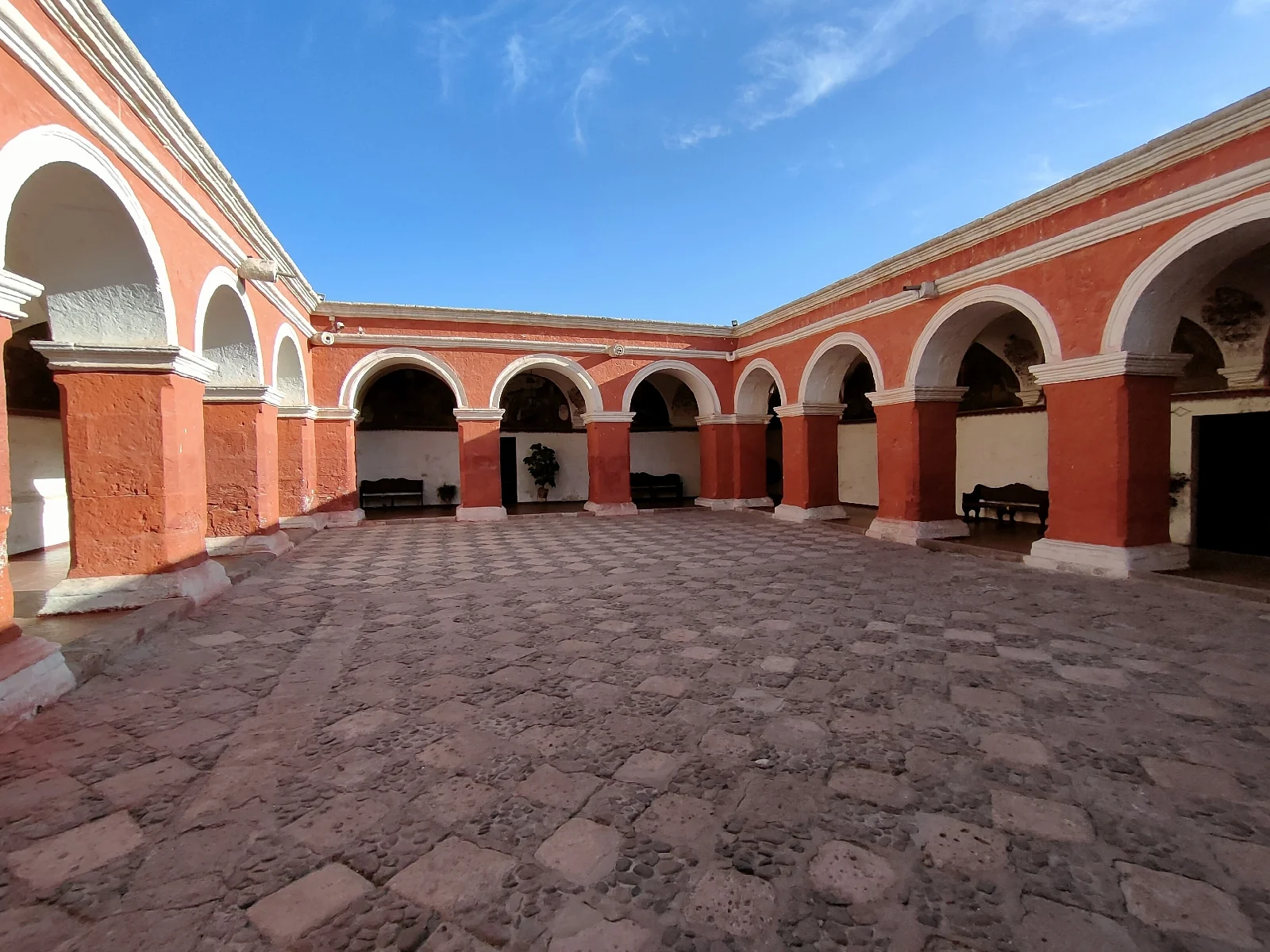 Patio colorido con arcos de sillar dentro del monasterio